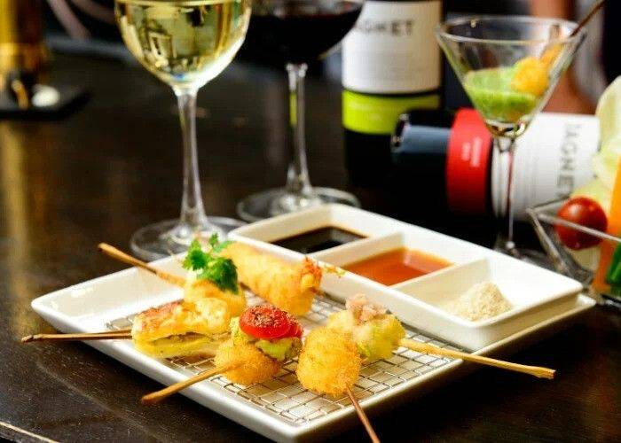 A serving of deep-fried skewers and sauces at Kushikatsu Gojoya in Osaka.